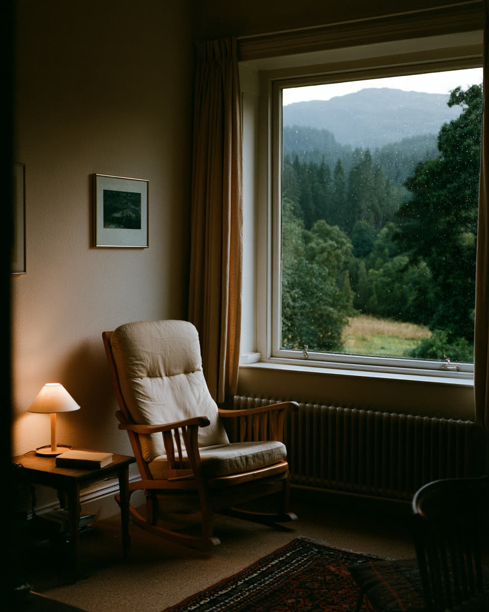 A simple wooden armchair beside a reading lamp